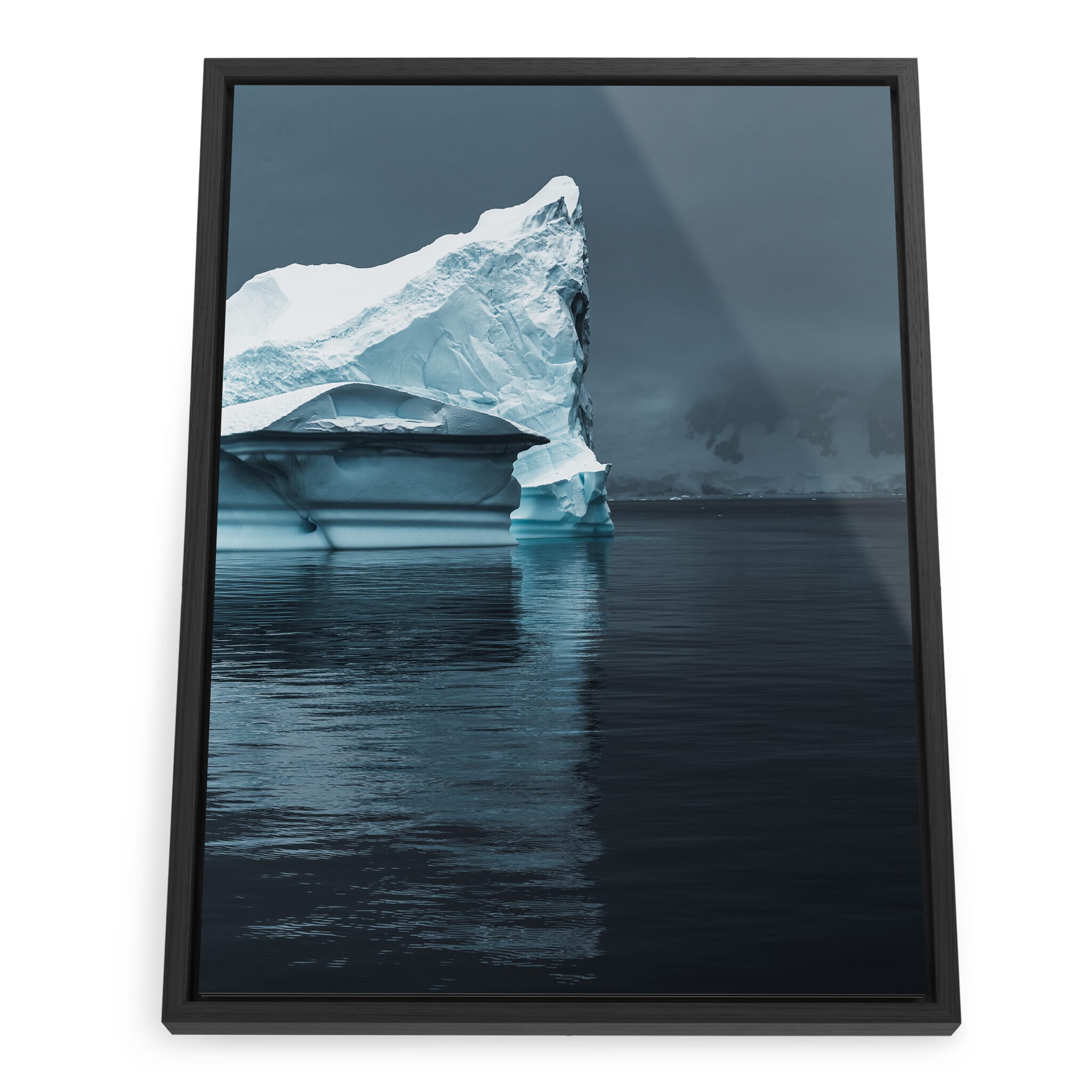 Framed photo print of sculpted iceberg reflected in calm, dark water