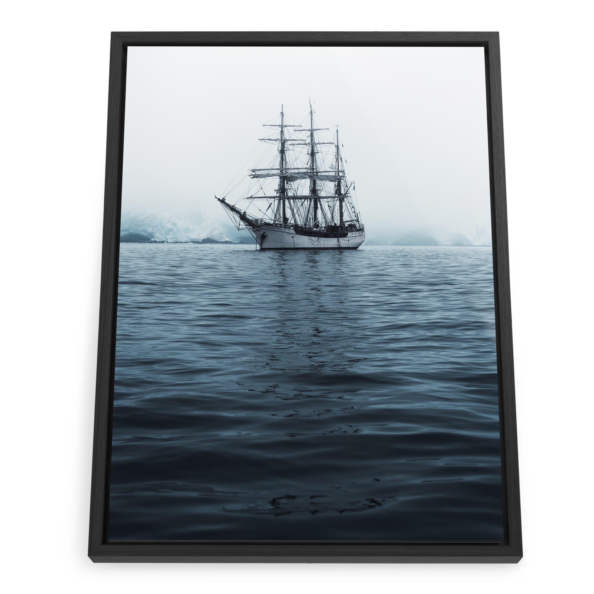 Framed photo print of a sailing ship moving through iceberg-filled waters