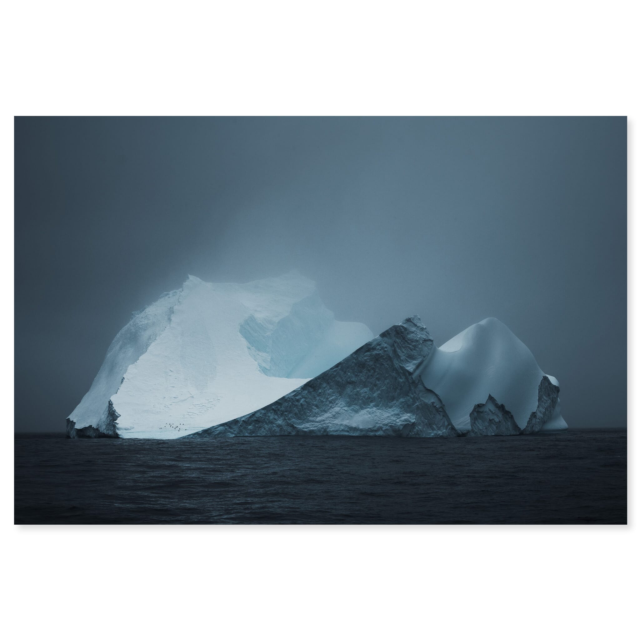 Fine art print of isolated iceberg beneath dramatic clouds in Antarctica