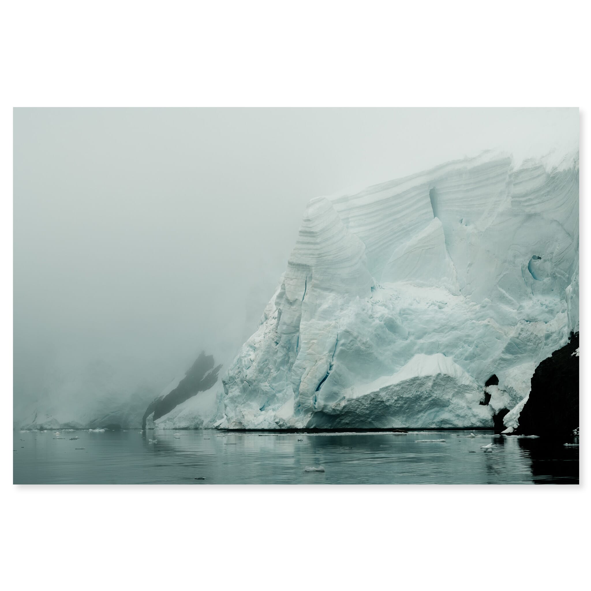 Fine art print of an iceberg in Antarctica emerging from dense fog