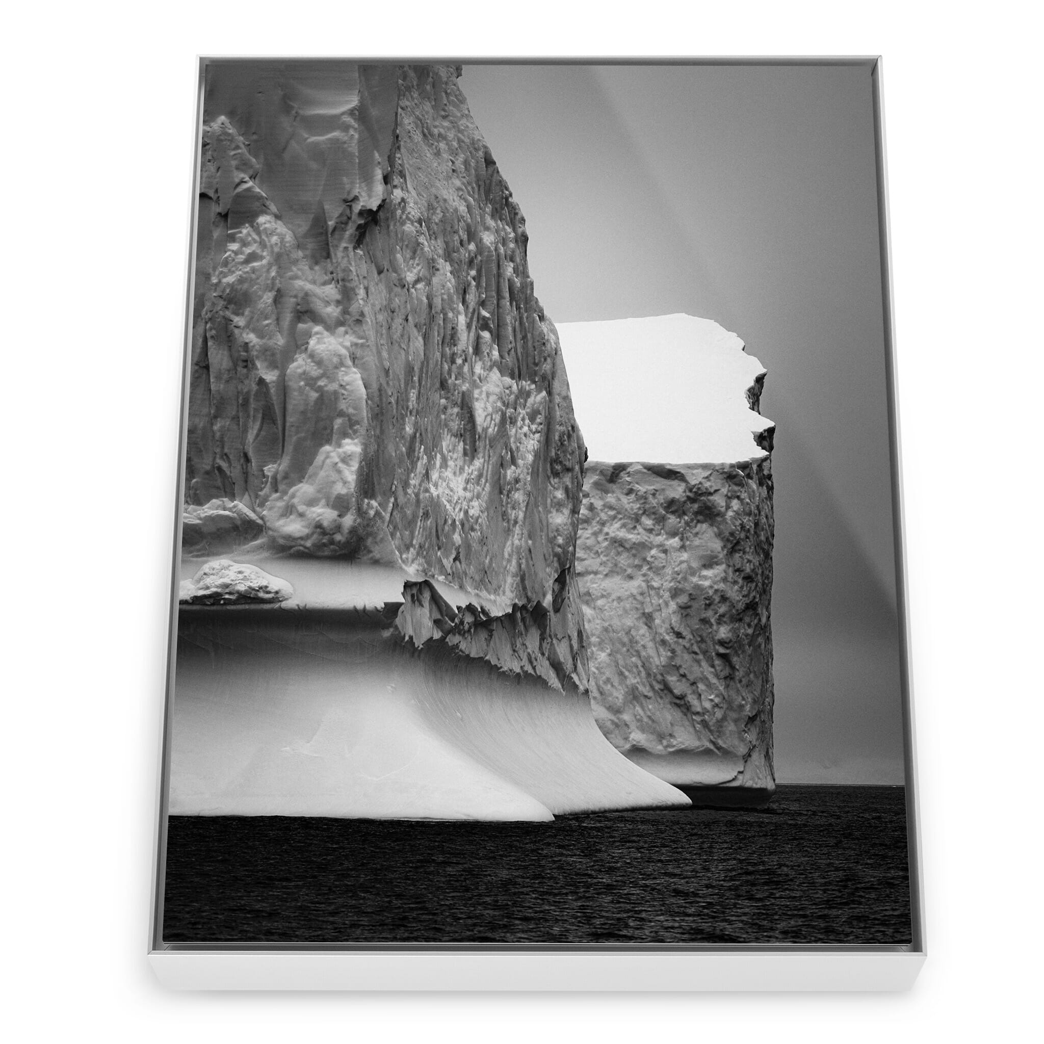 Framed photo print of textured iceberg surfaces under soft light