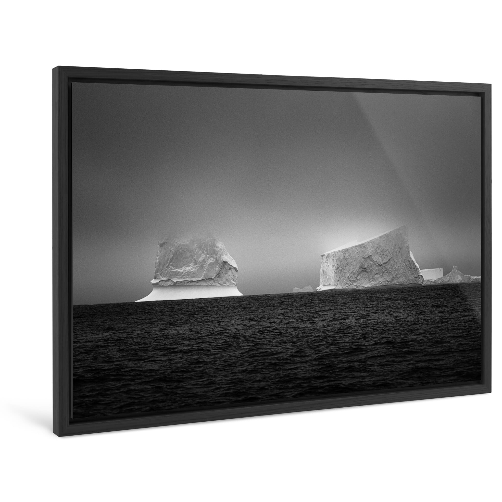 Framed photo print of two icebergs showing intricate shapes in black and white