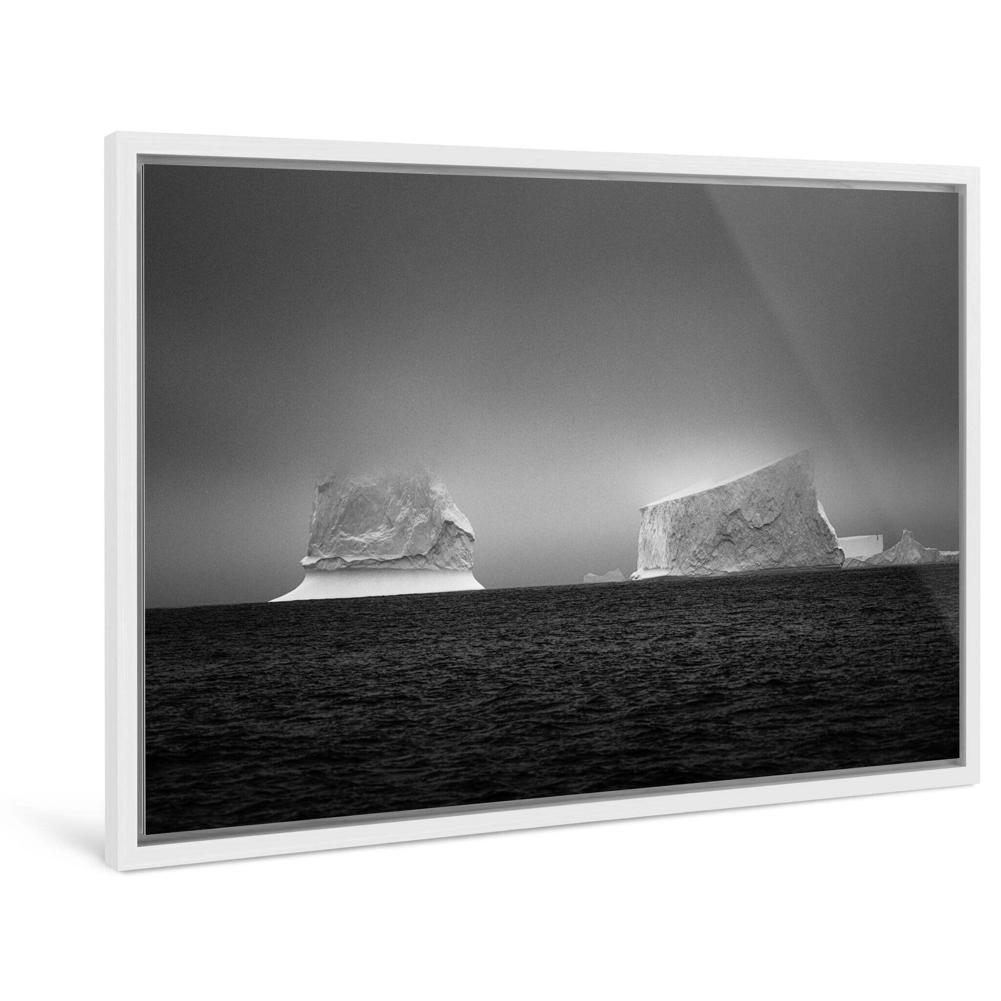Framed photo print of two icebergs capturing sculptural forms in a frozen landscape