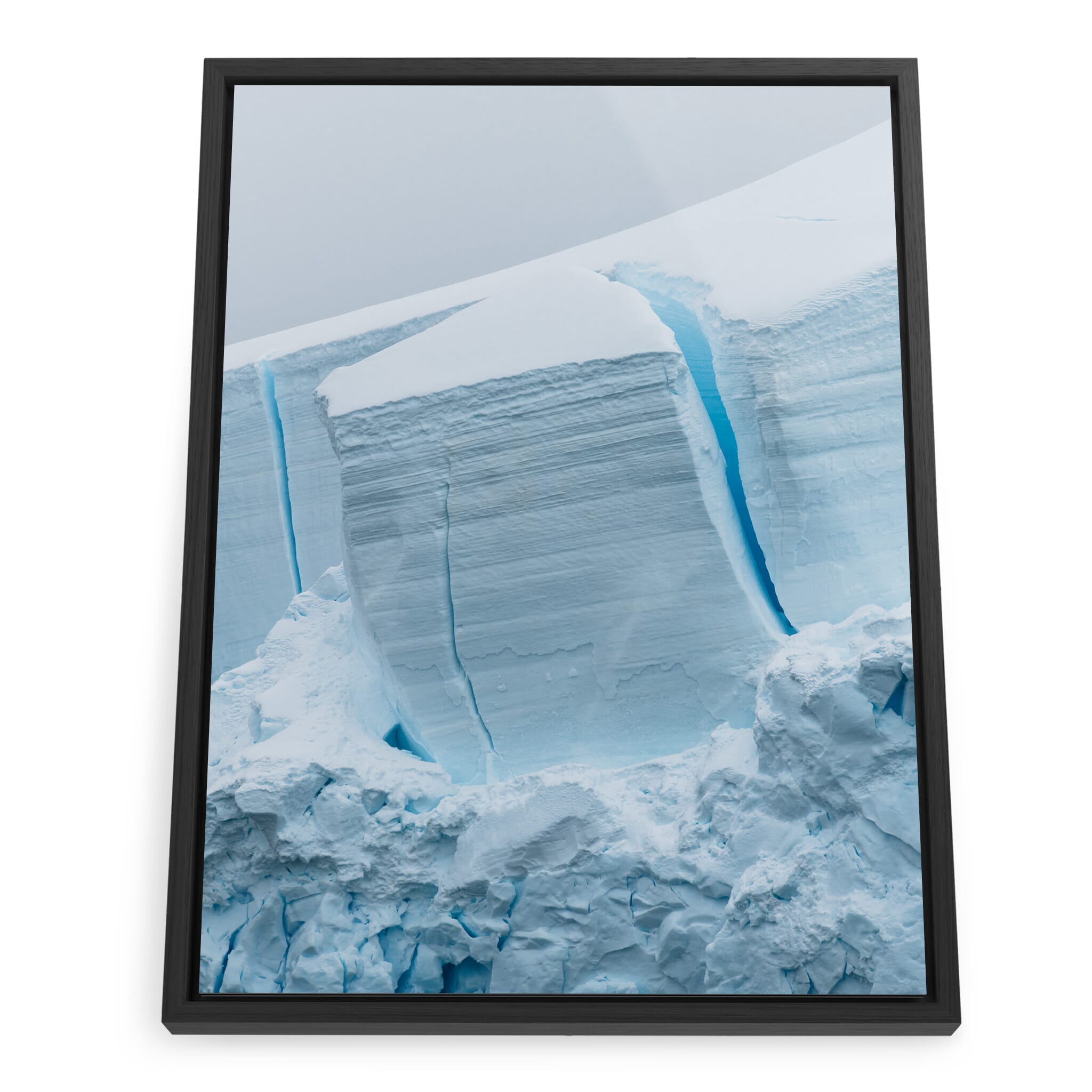 Framed photo print of sculpted glacier illuminated in soft blue light