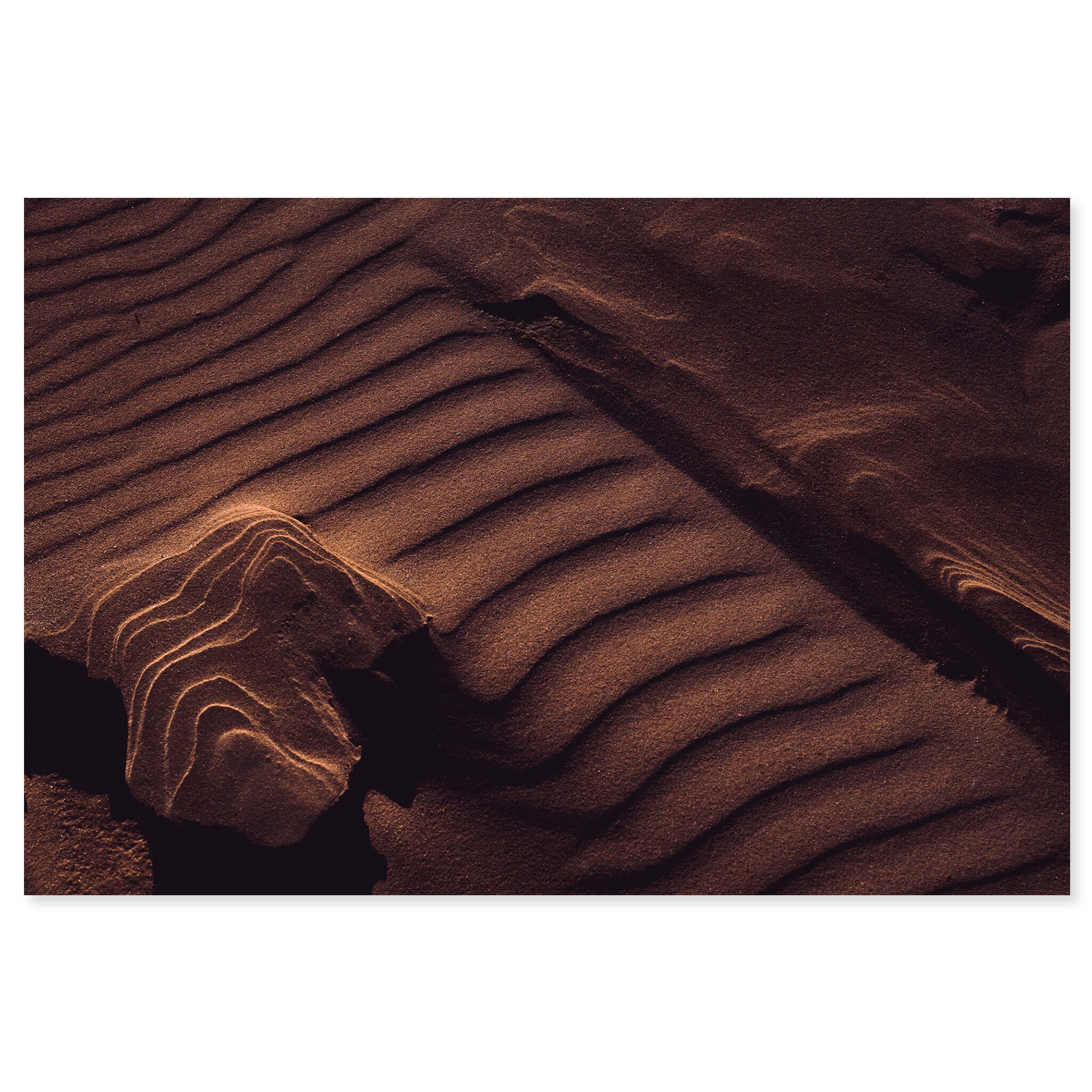 Fine art print of layered sand formations shaped by wind and light