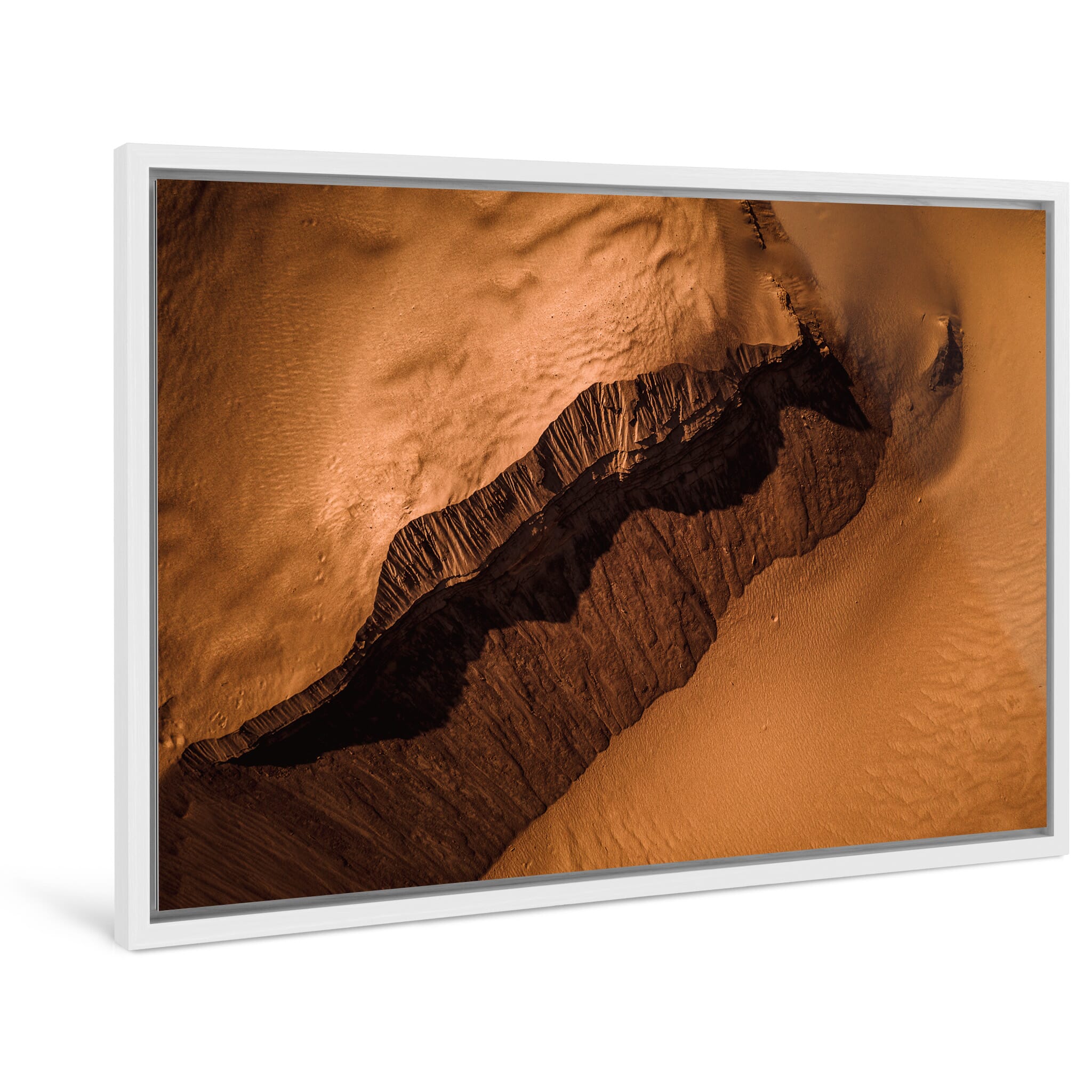 Framed photo print of abstract shapes in a stripped-down sandy environment