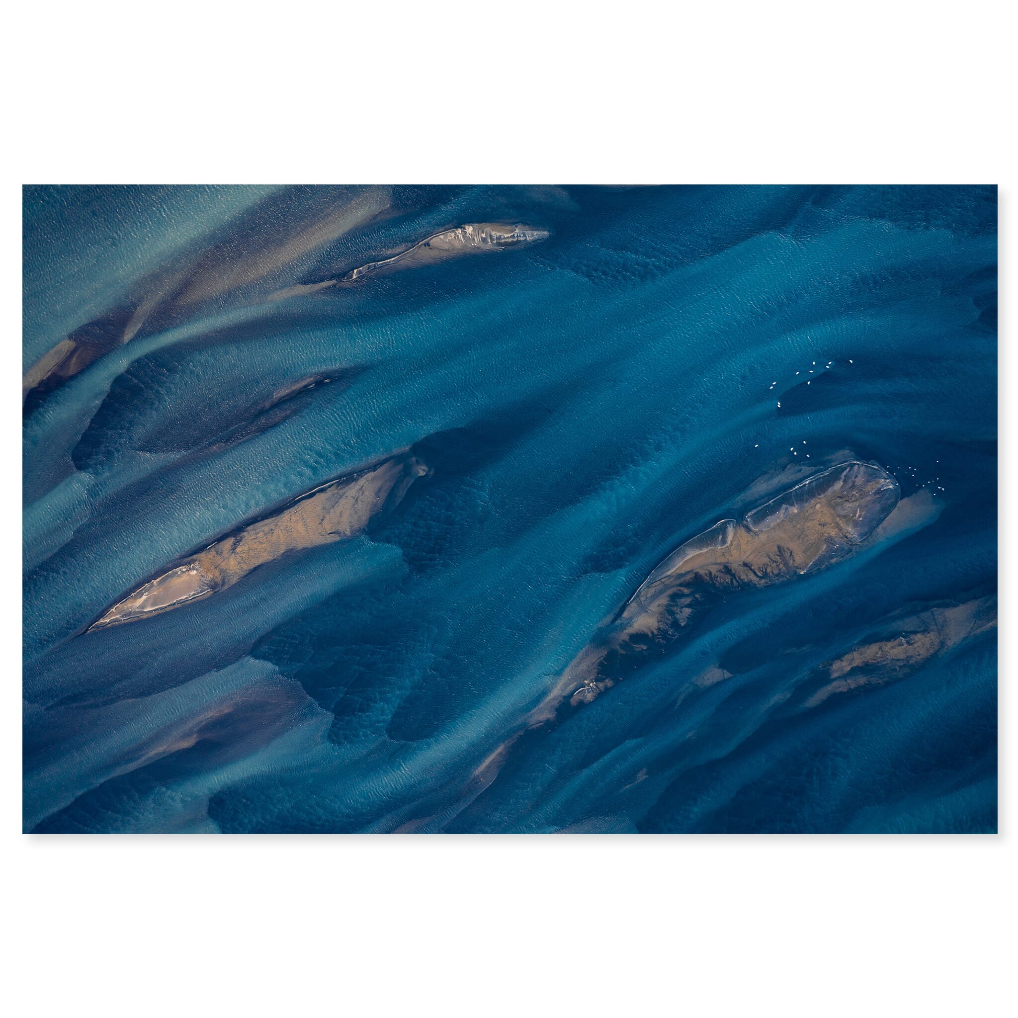 Fine art print of an aerial glacial river in Iceland with vivid blue tones