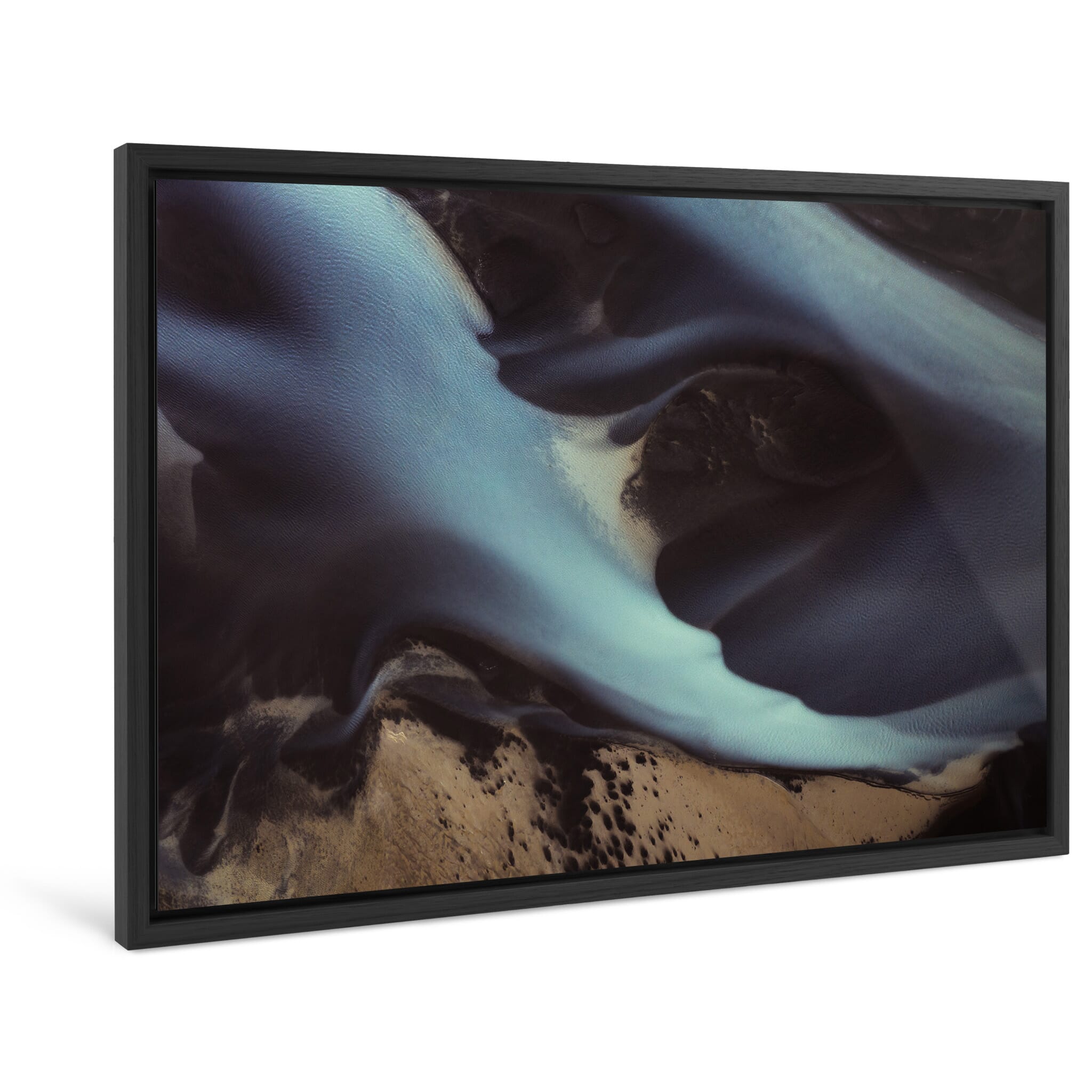 Framed photo print of glacial river sediment creating swirling shapes in the sand