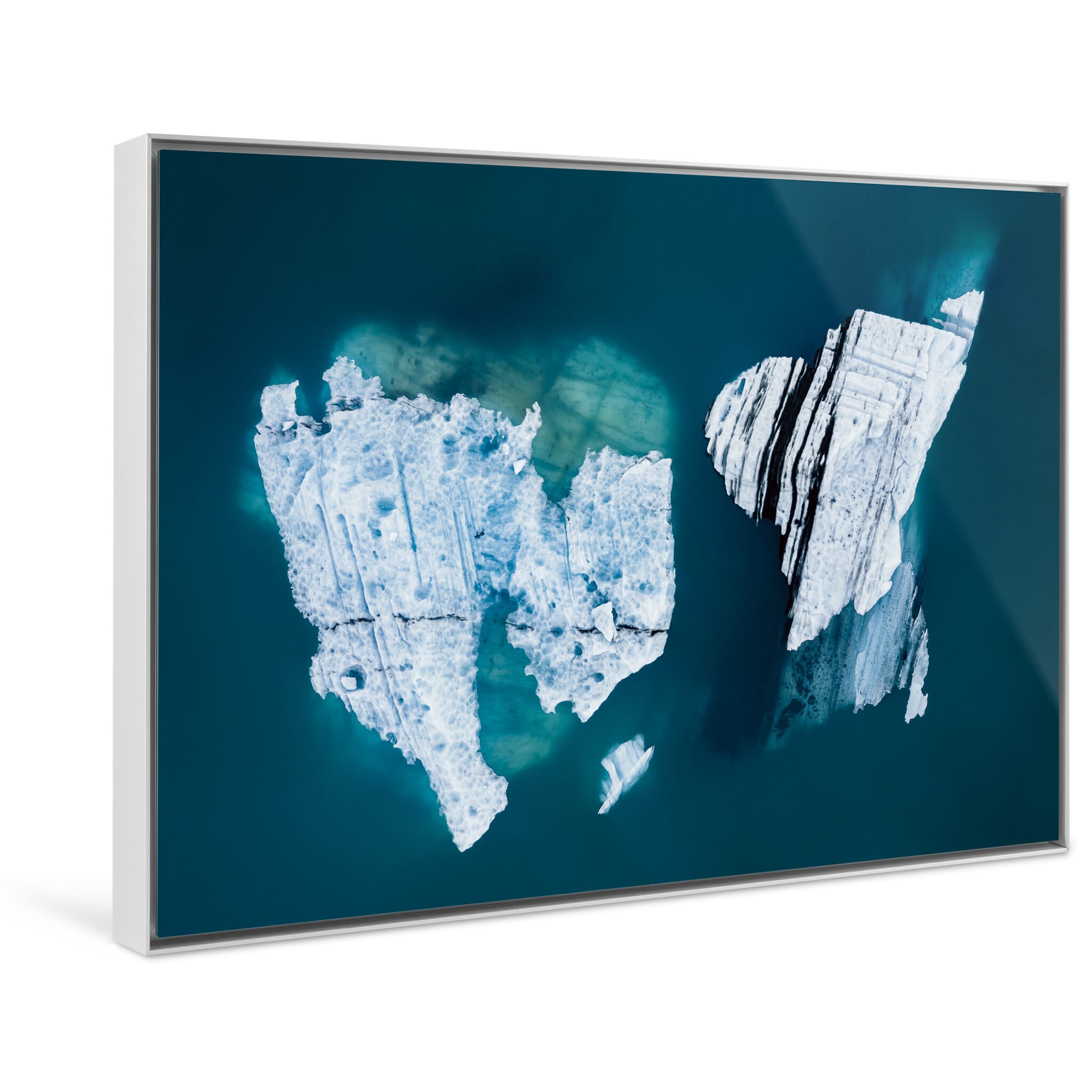 Framed photo print of surreal iceberg shapes eroded by time and temperature seen from the air