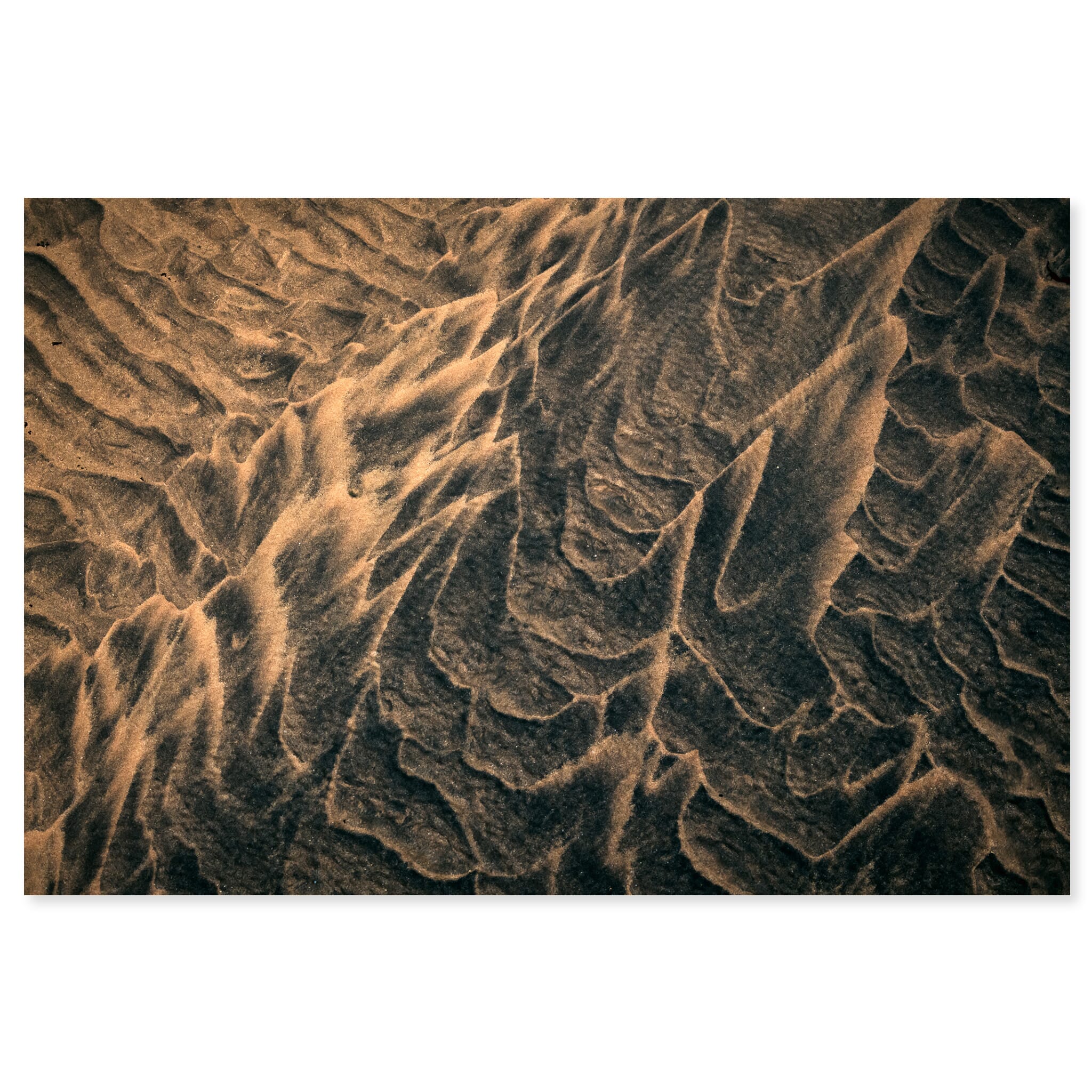 Fine art print of wave-shaped sand forms with dark and bright tones in Iceland
