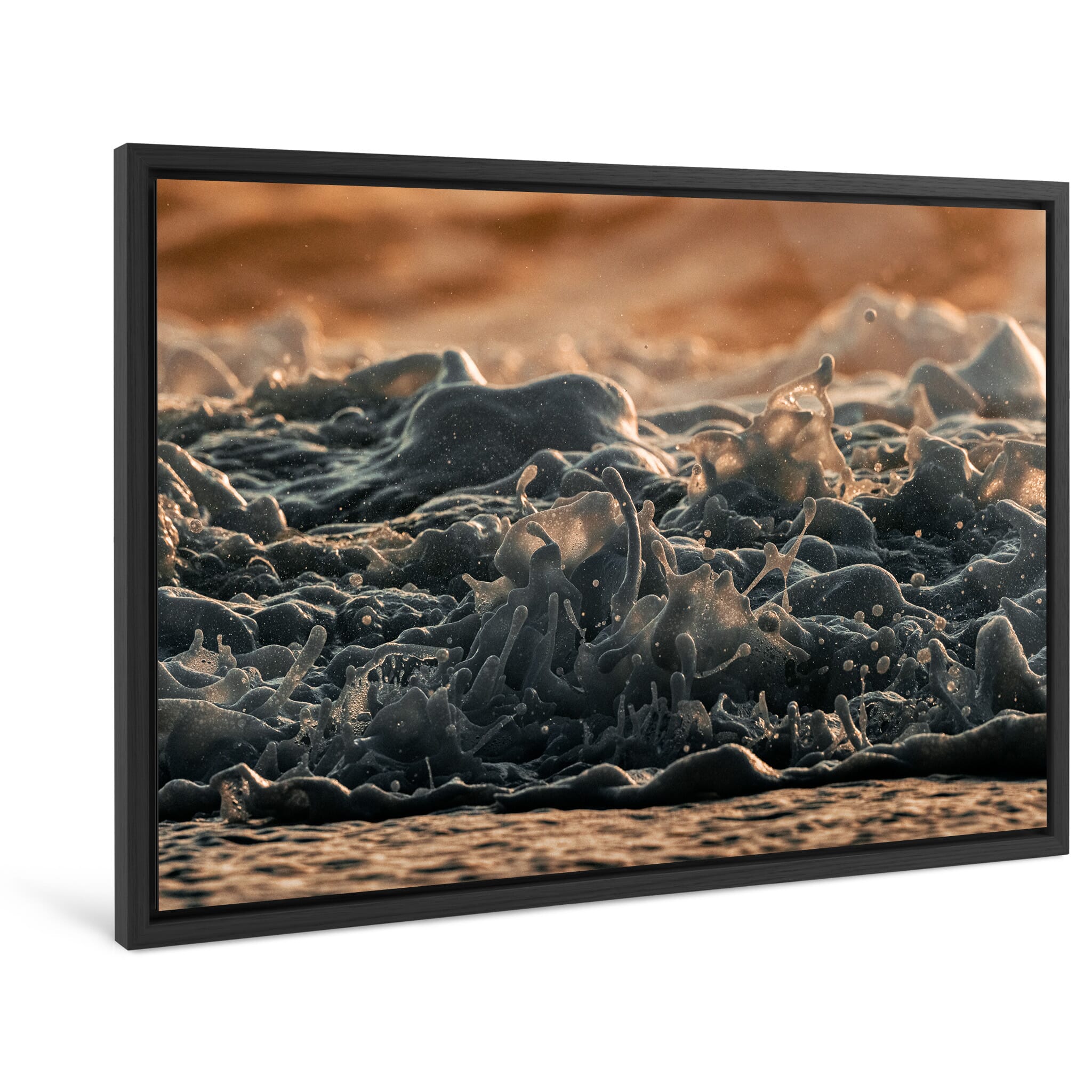 Framed photo print of dynamic waves meeting volcanic sand in winter light