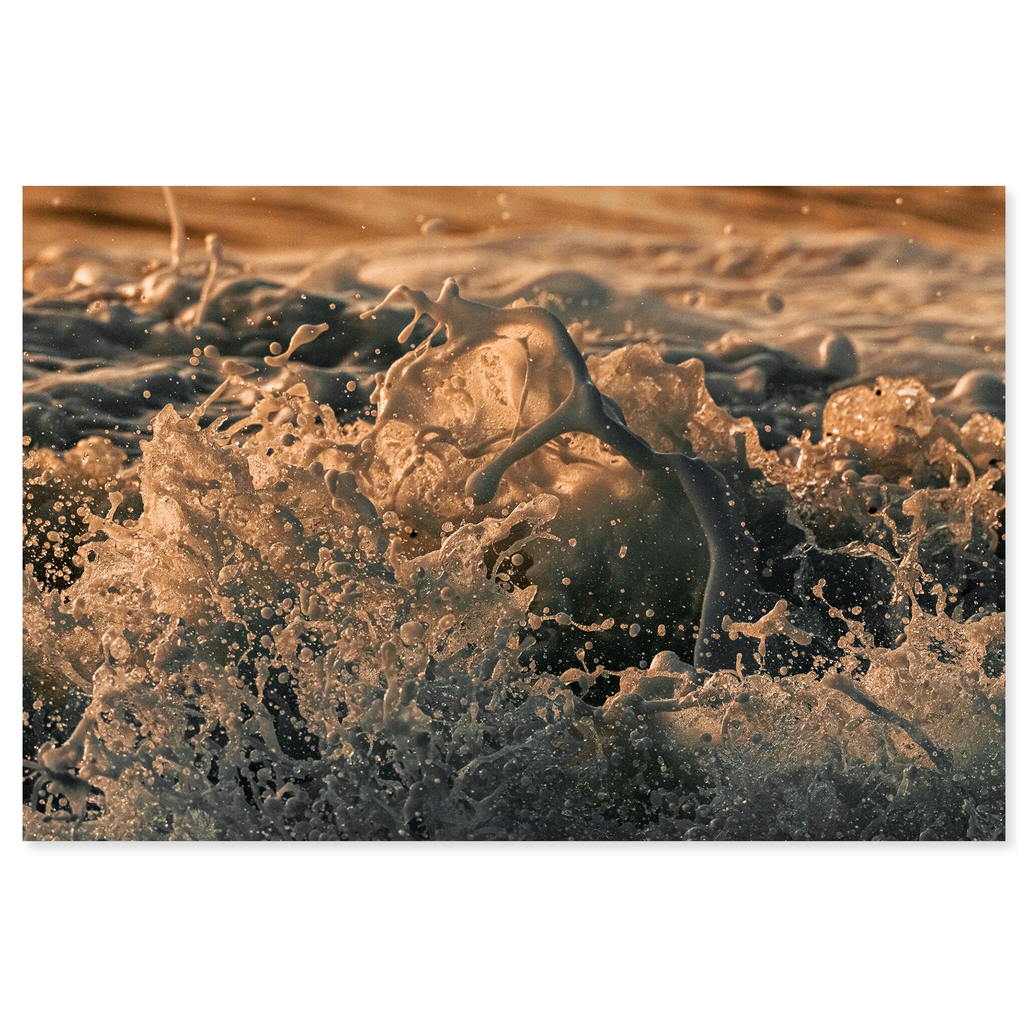 Fine art print of a close-up wave on Iceland’s black sand beach under warm sunrise