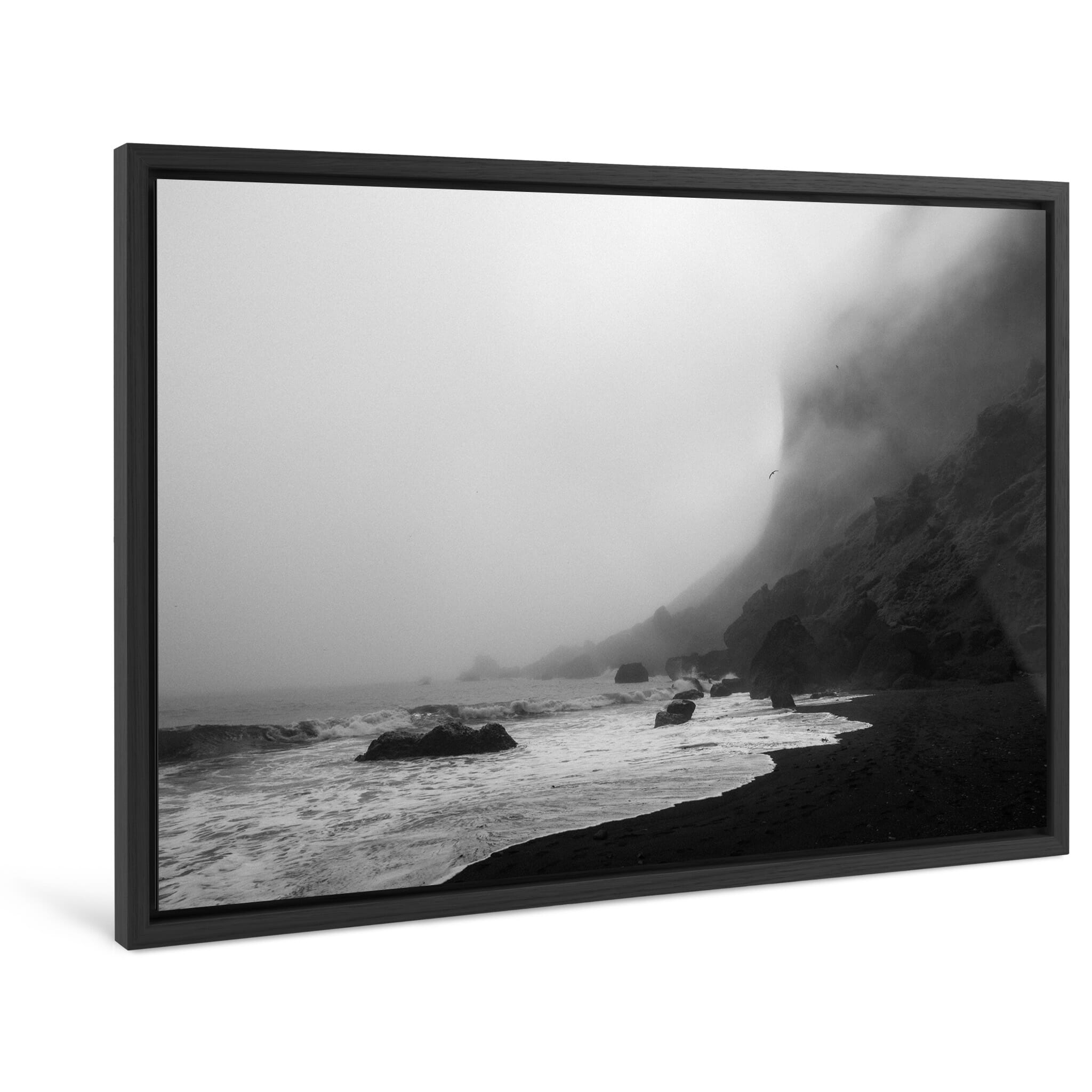 Framed photo print of misty ocean view with dramatic cliffs and black sand shore