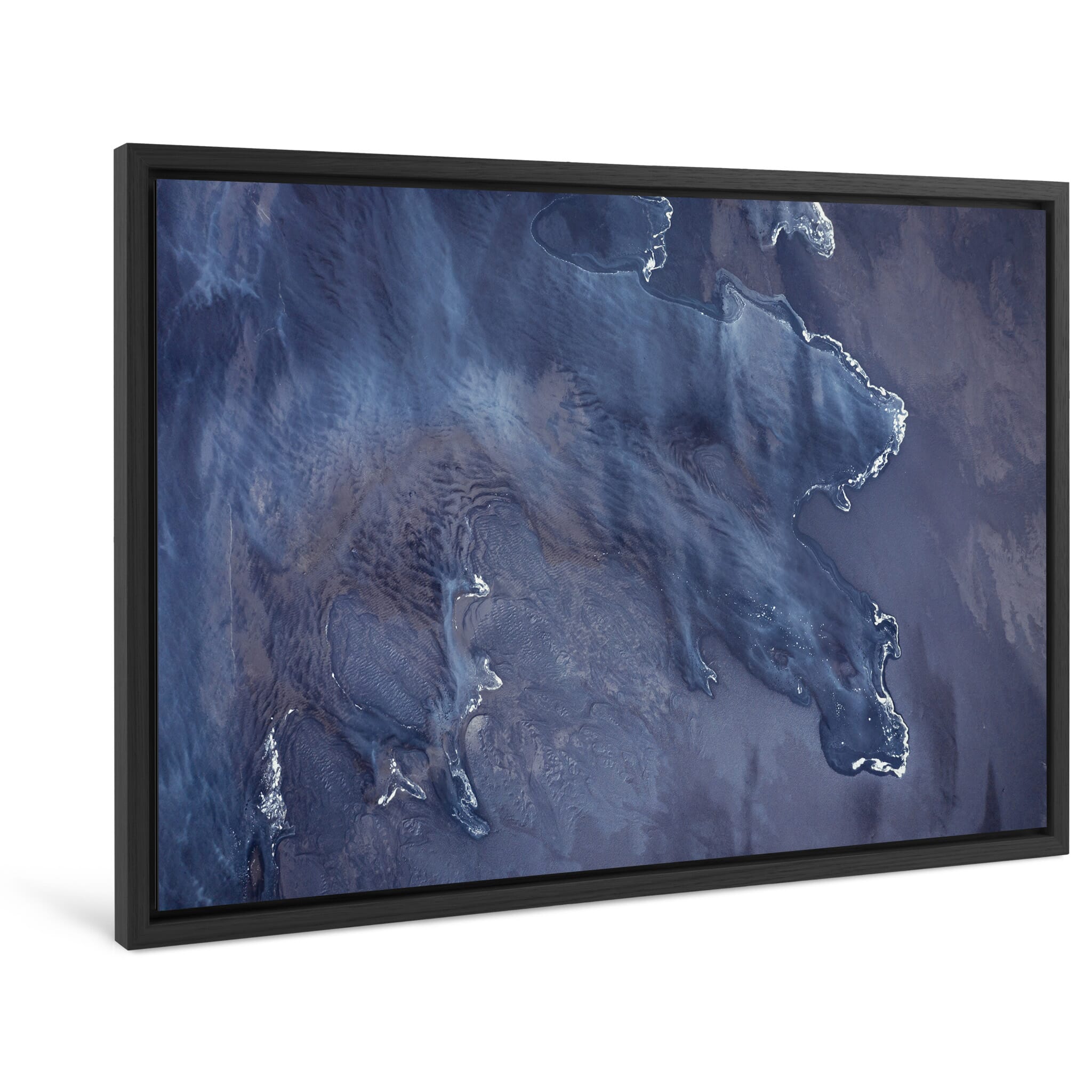 Framed photo print of swirling tide and dark sand captured from above