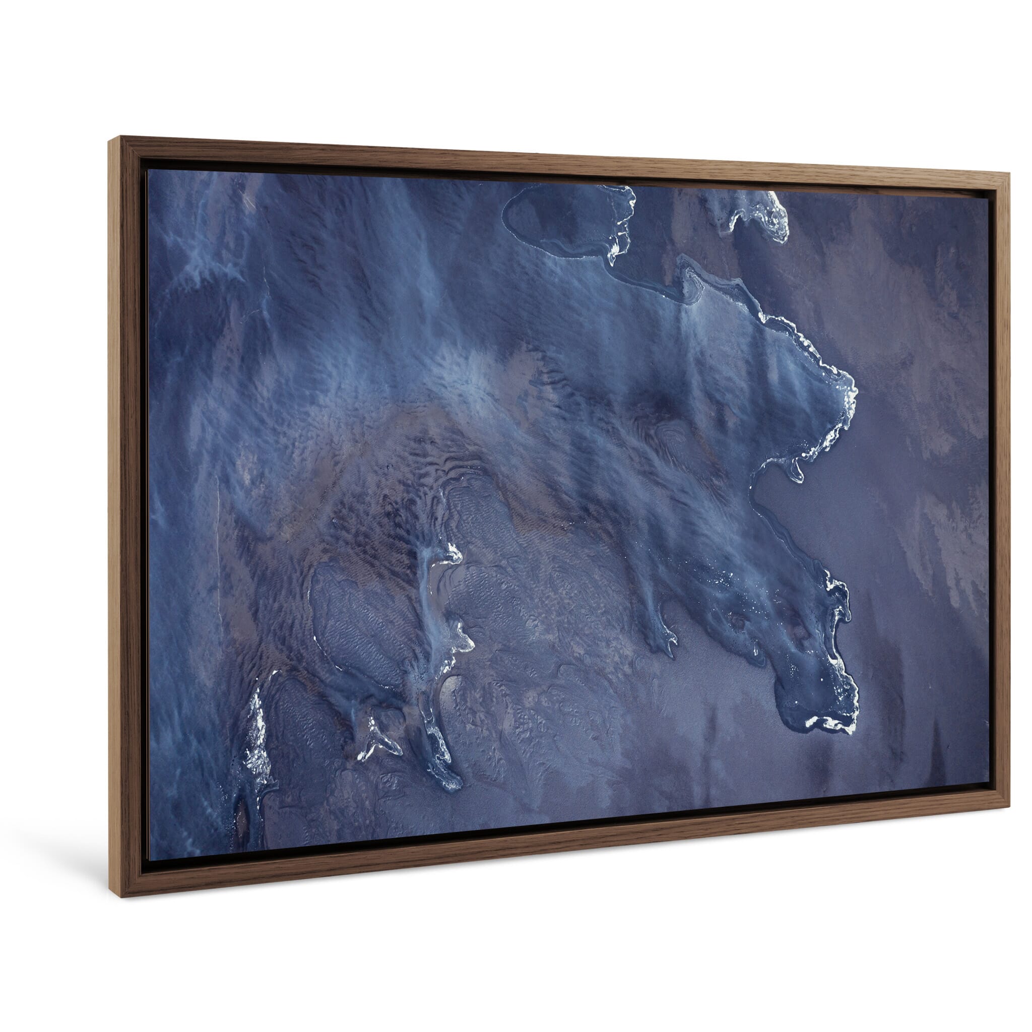 Framed photo print of sediment-laden water blending with black sand