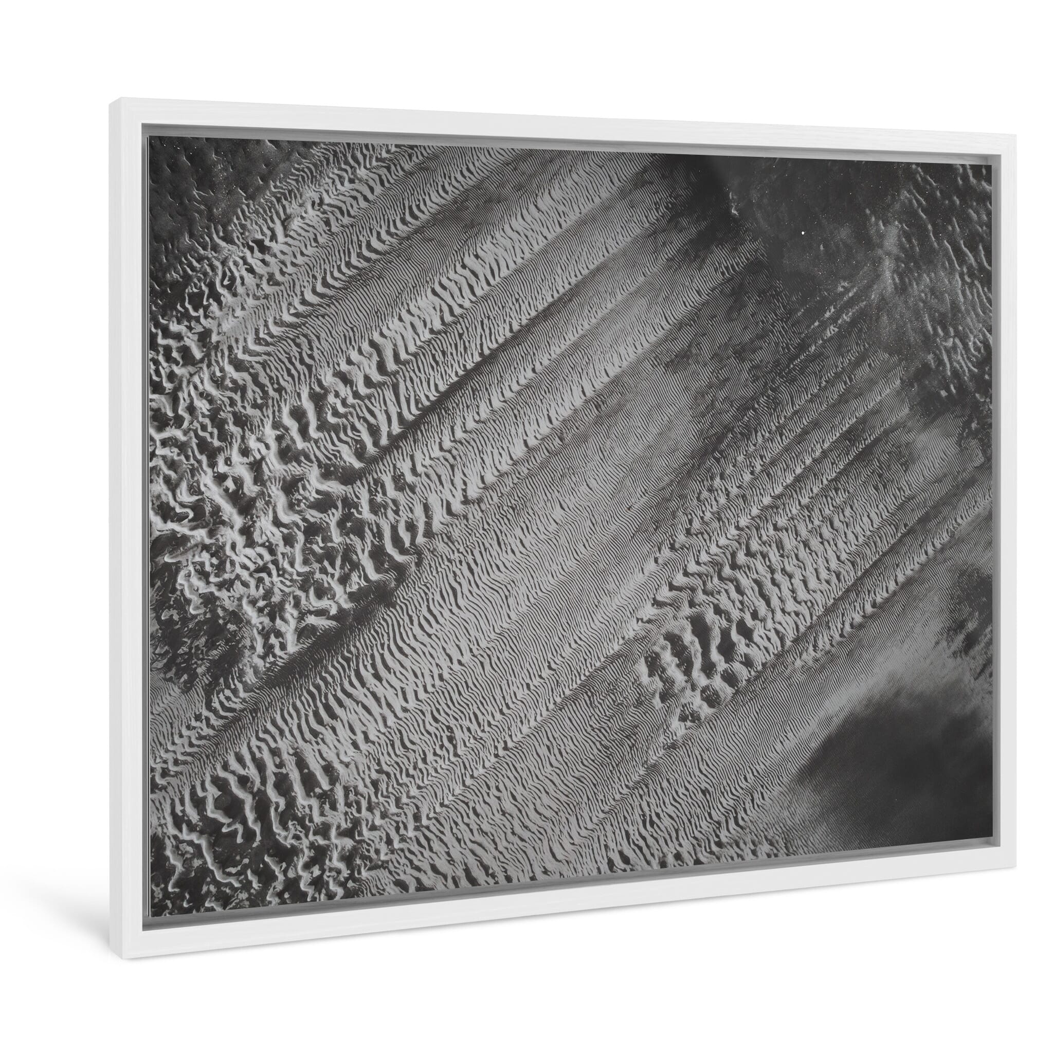 Framed photo print of abstract aerial formations resembling glitch patterns