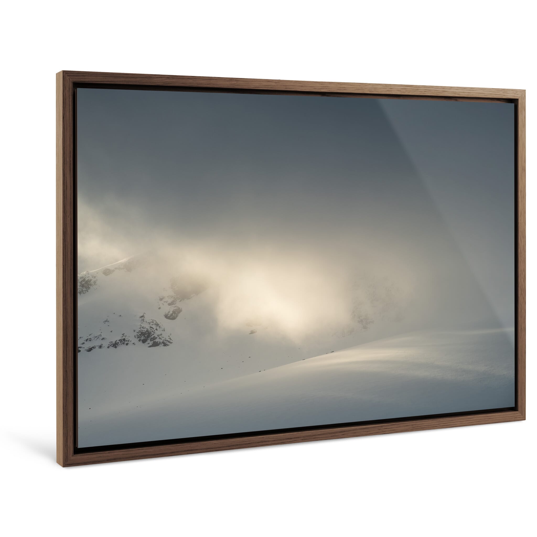 Framed photo print of alpine scene where sunlight highlights snow-covered terrain