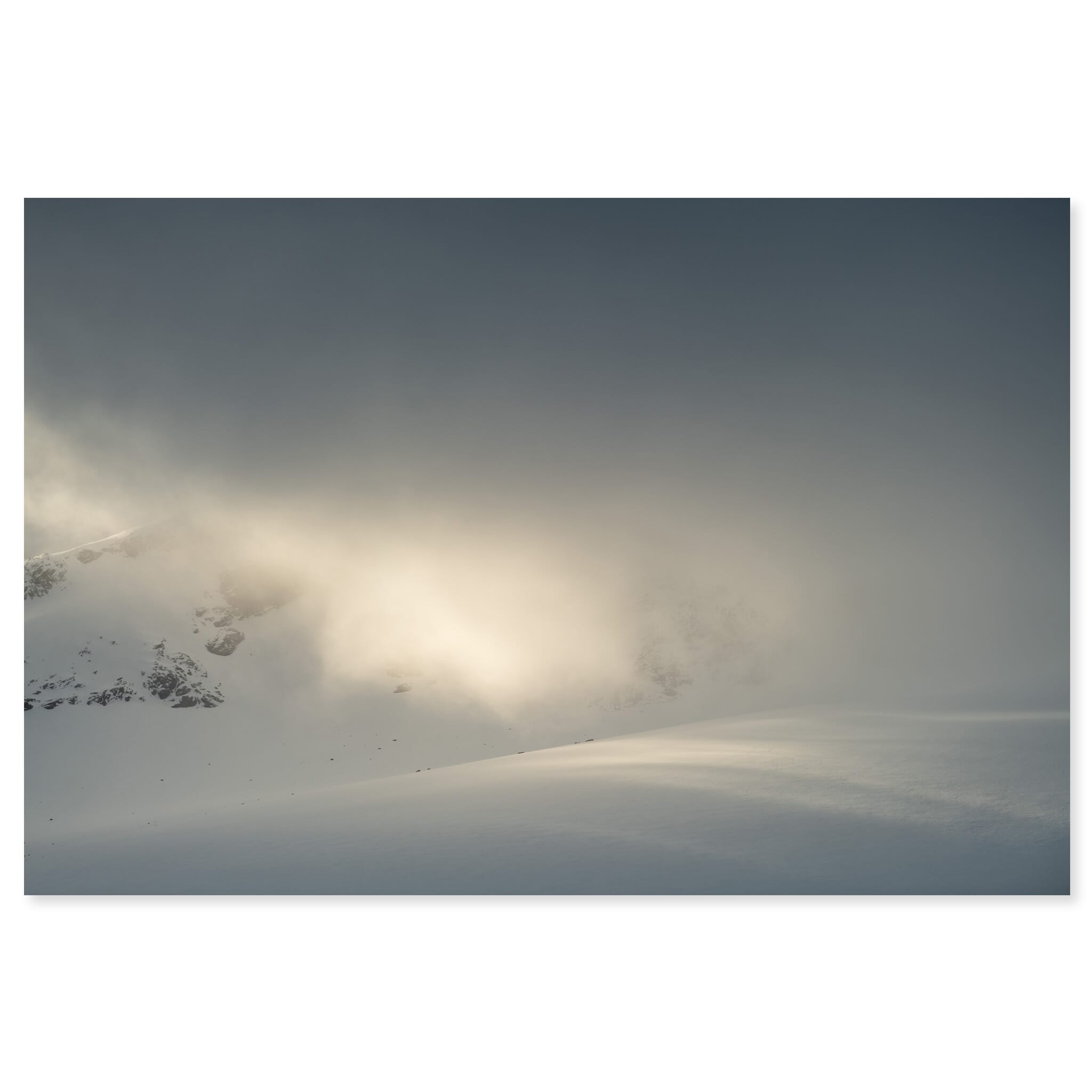 Fine art print of snow-covered mountain landscape in Norway with spotlight of sunlight