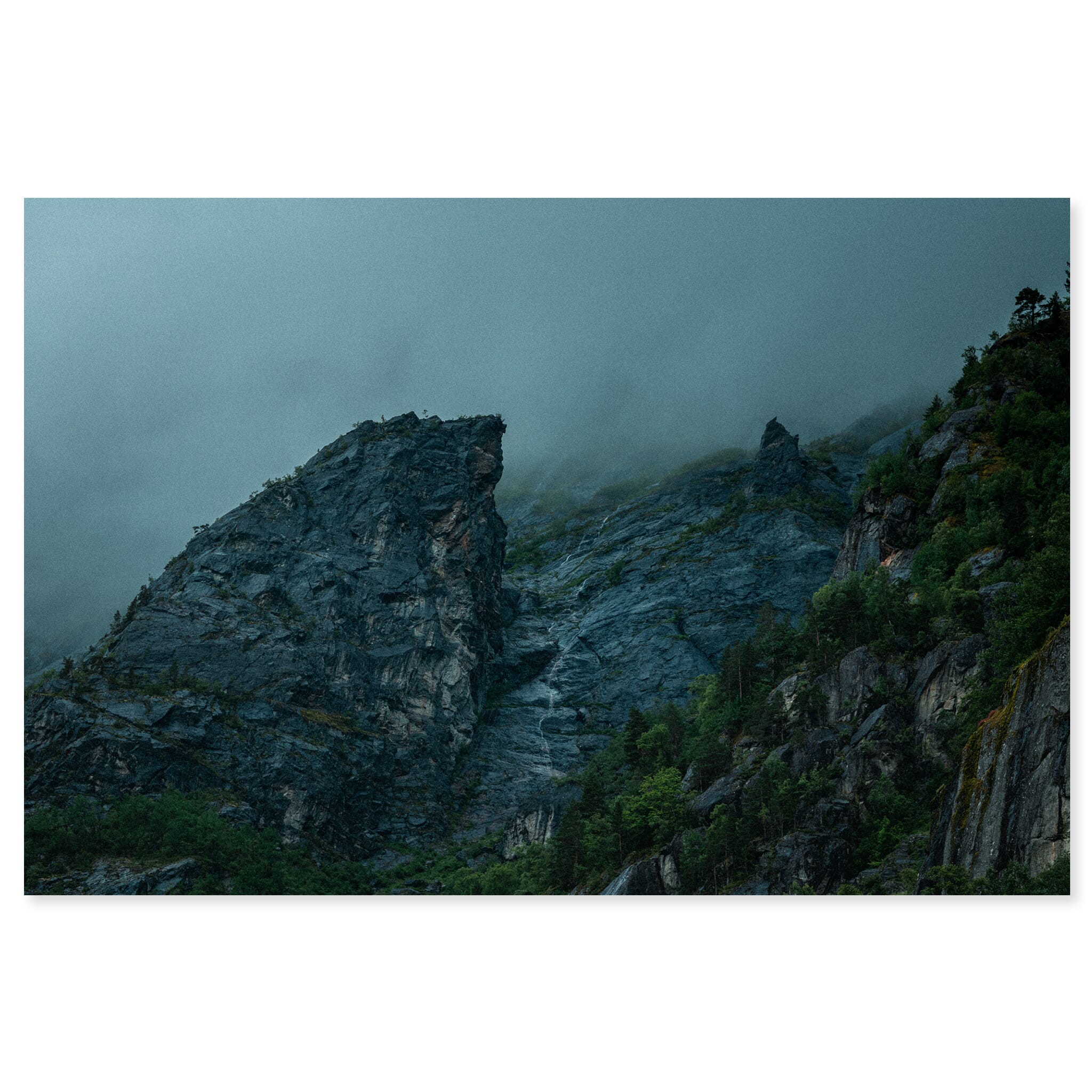 Fine art print of dark cliff landscape with steep rock formations and soft light