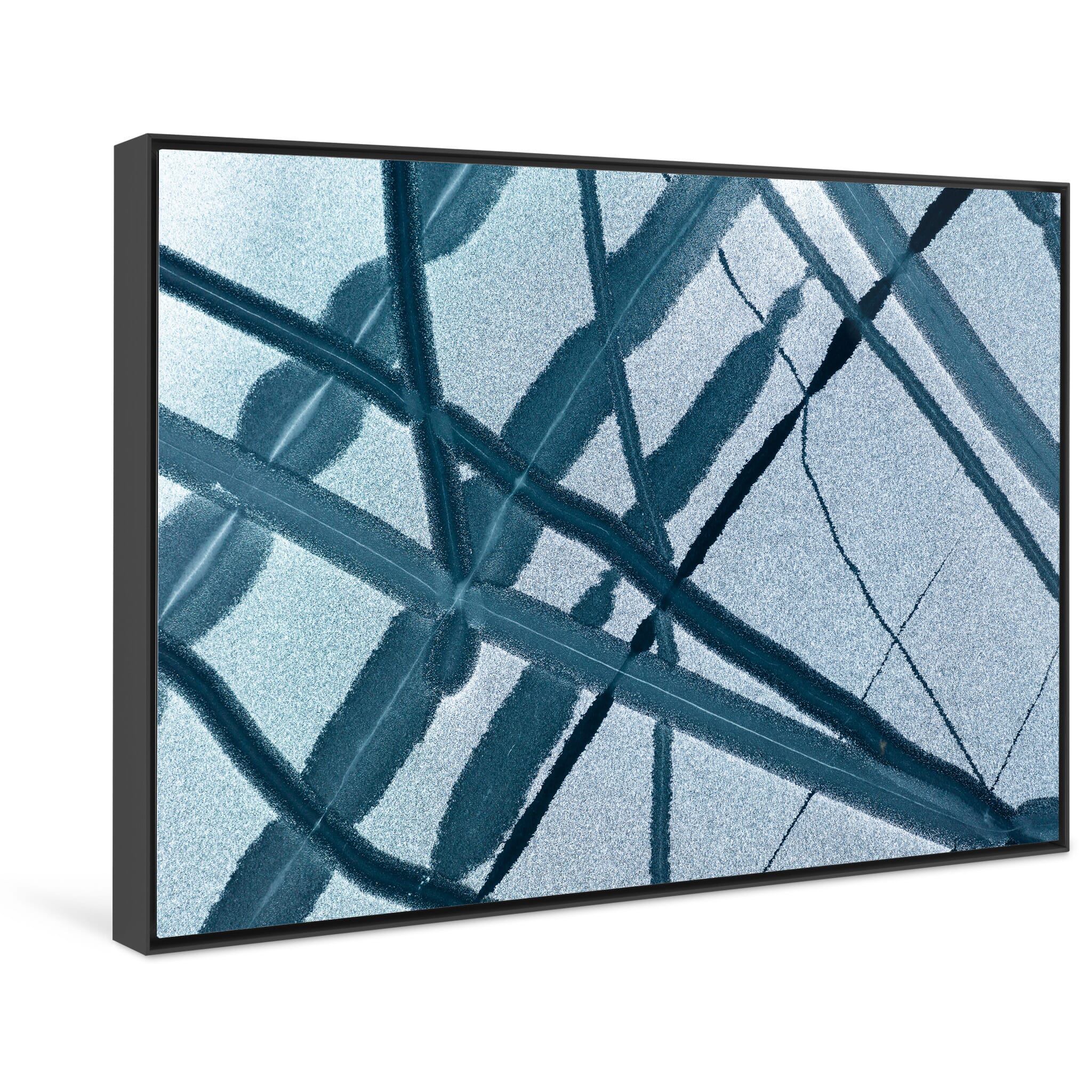 Framed photo print of cracked and broken ice forming arrow-like snowdrift patterns