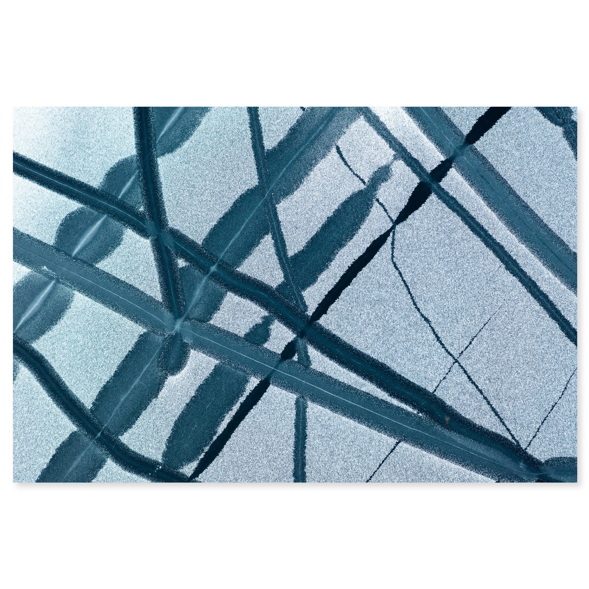 Fine art print of abstract patterns with melted holes and cracks in frozen lake ice