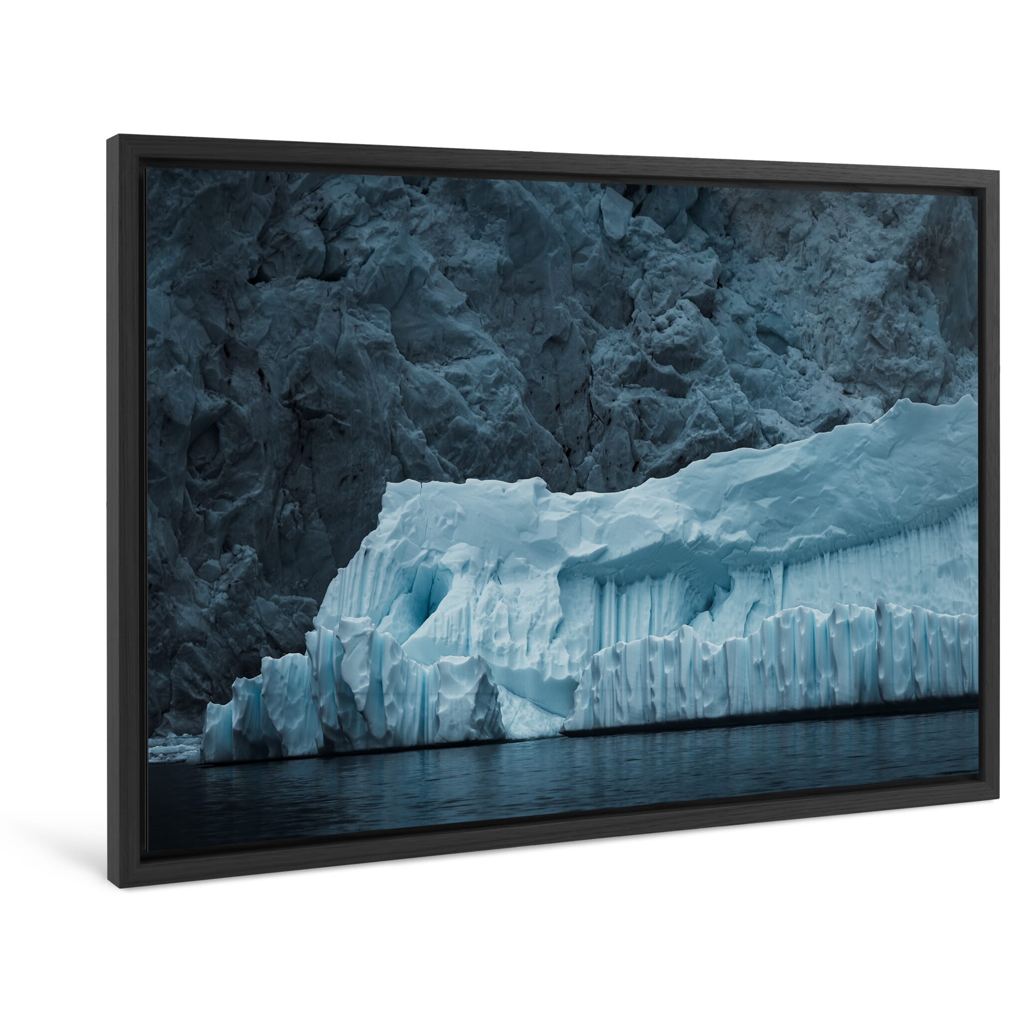 Framed photo print of a large iceberg showing carved curves from melting