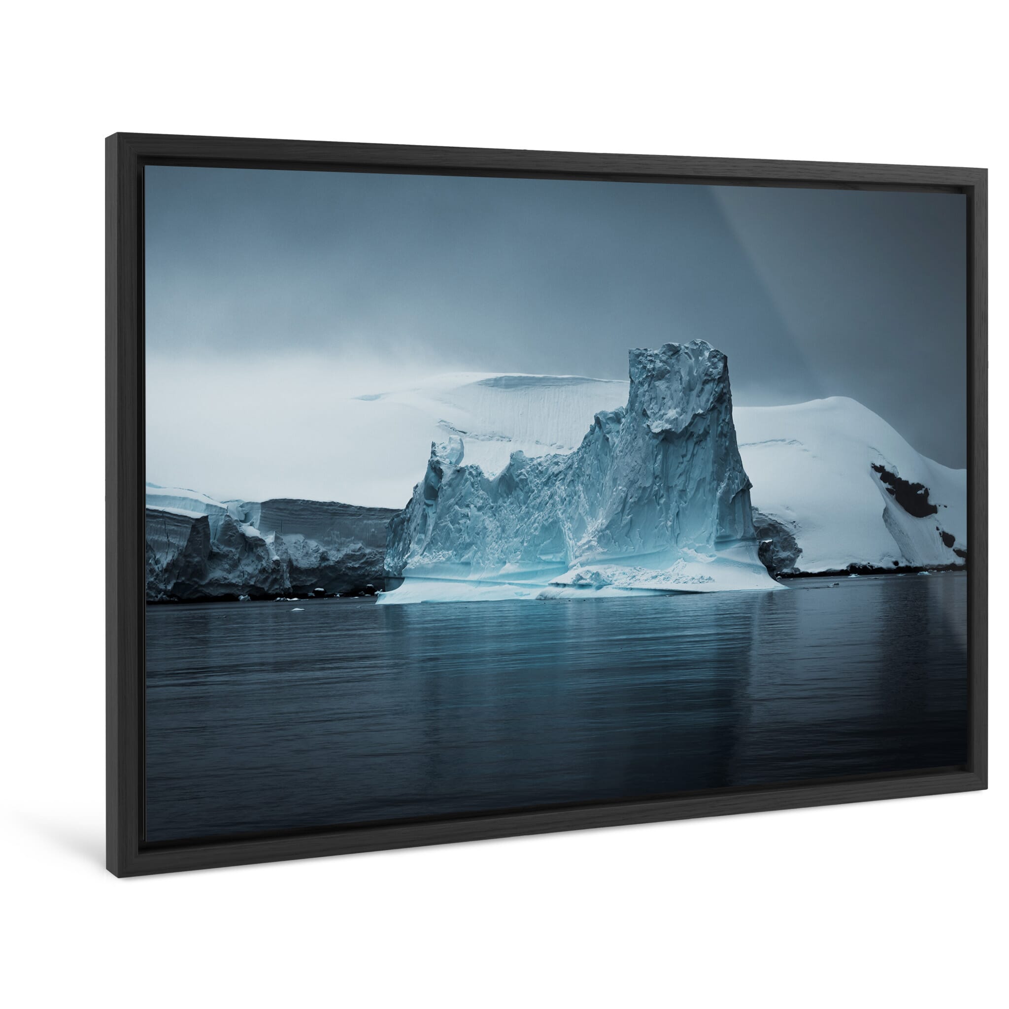 Framed photo print of a massive iceberg shaped by wind and melting