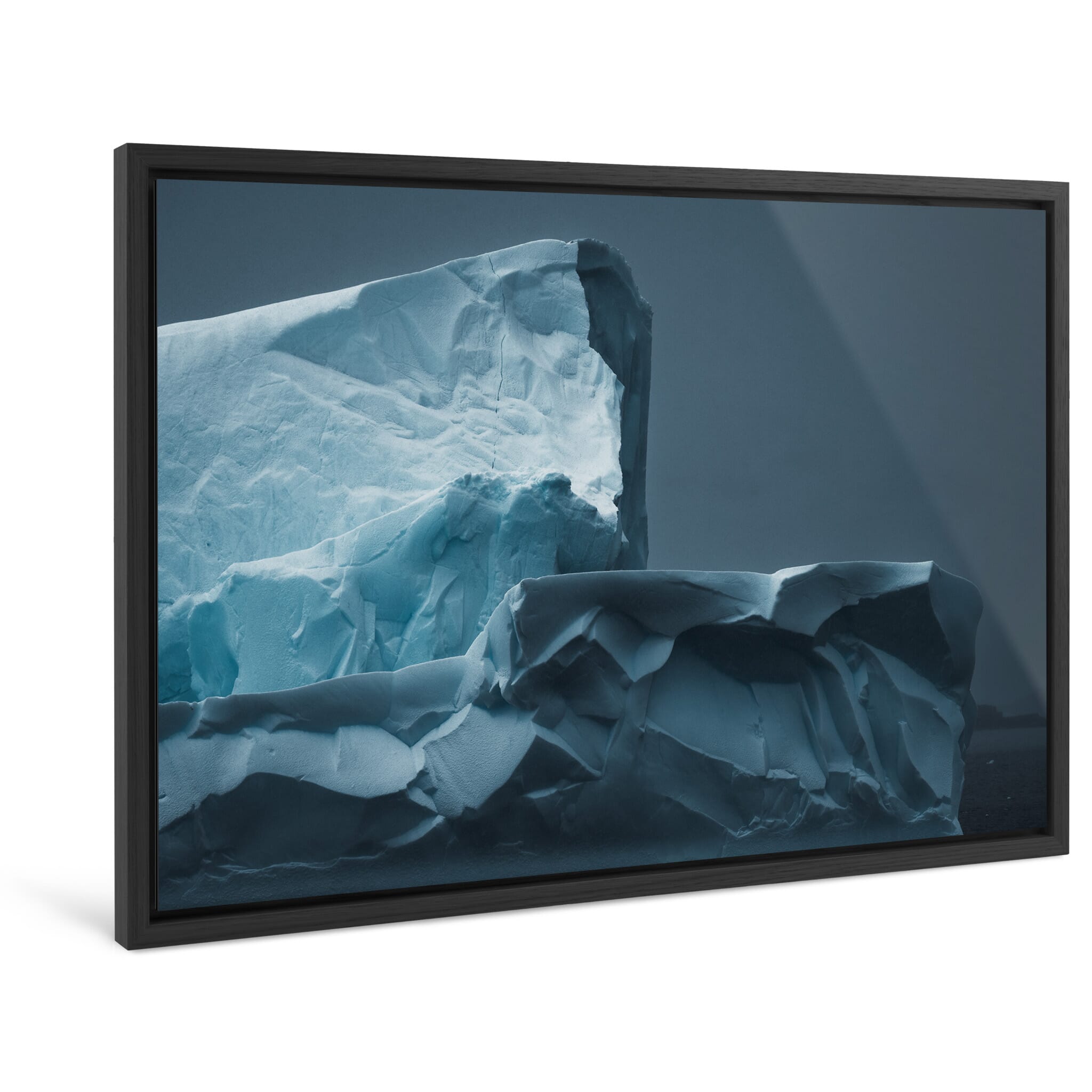 Framed photo print of sculpted iceberg with deep curves and shadowed textures