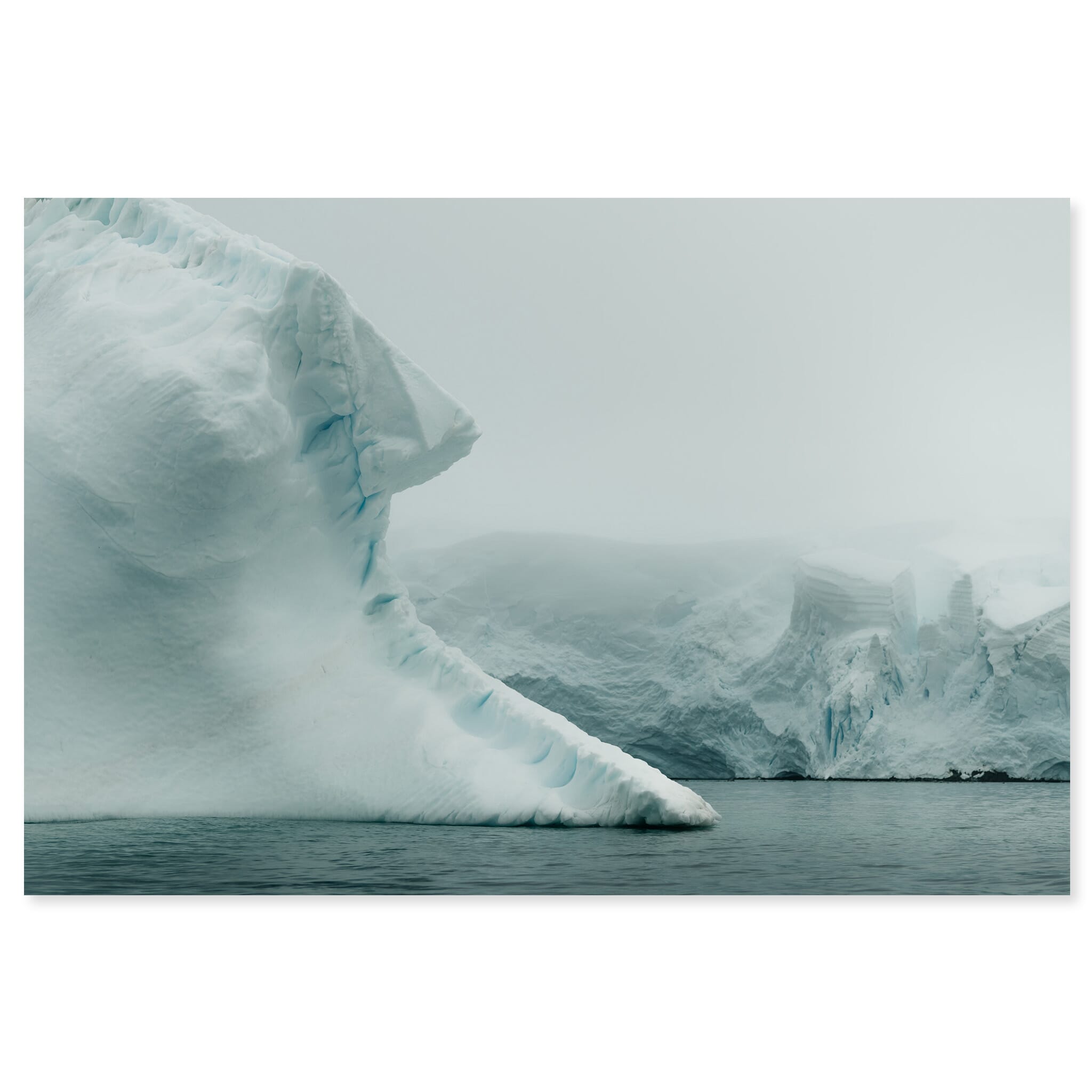 Fine art print of an iceberg shrouded in fog near the Melchior Islands in Antarctica