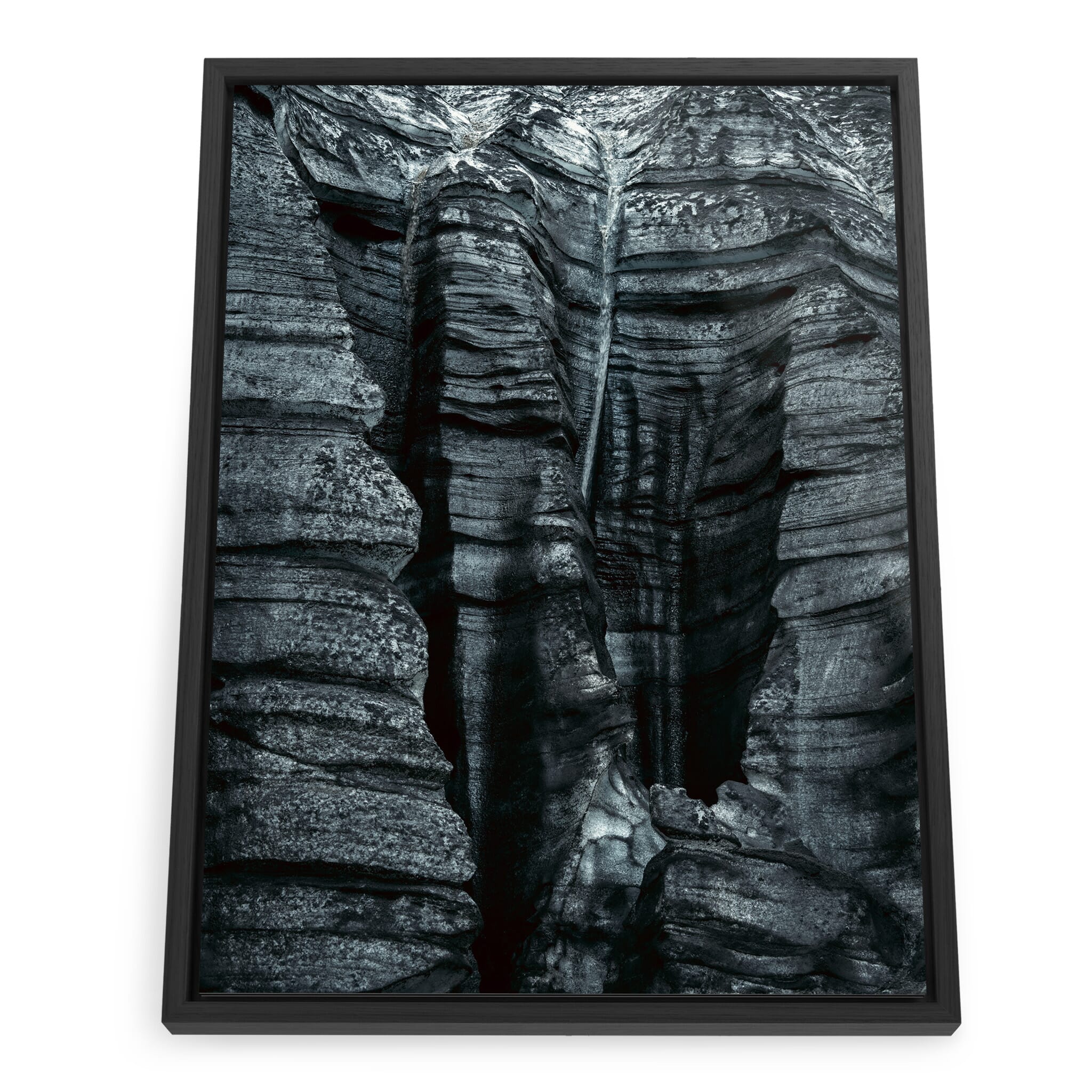 Framed photo print of dark glacial ice with volcanic sediment patterns