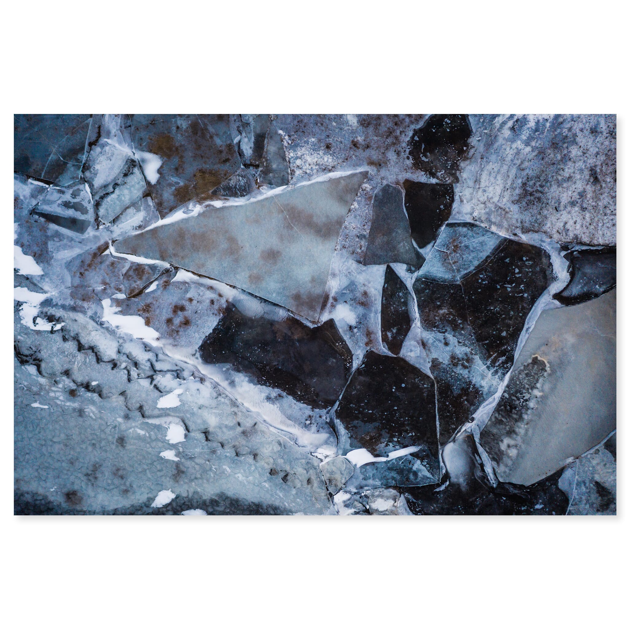 Fine art print of aerial view of textured winter ice with puzzle-like patterns in Iceland