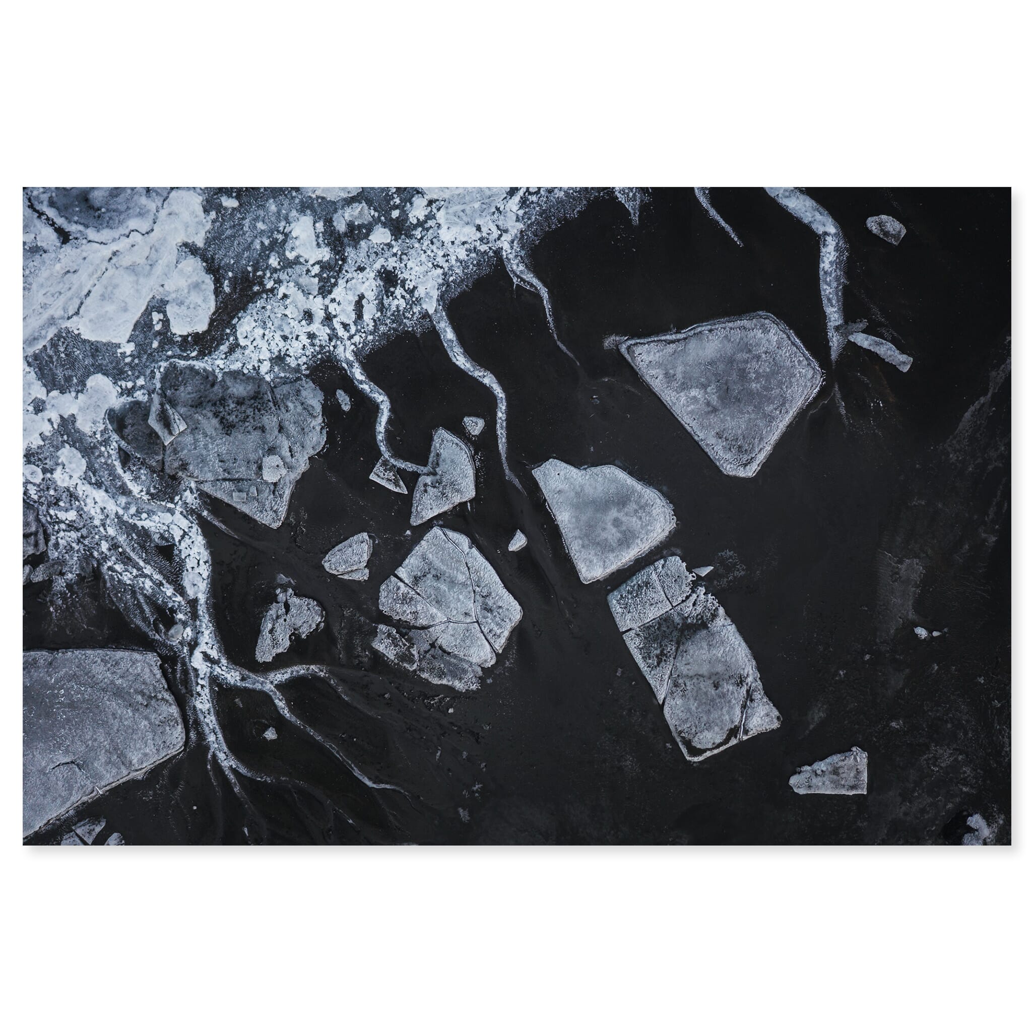Fine art print of a dried glacial river with volcanic sand and ice
