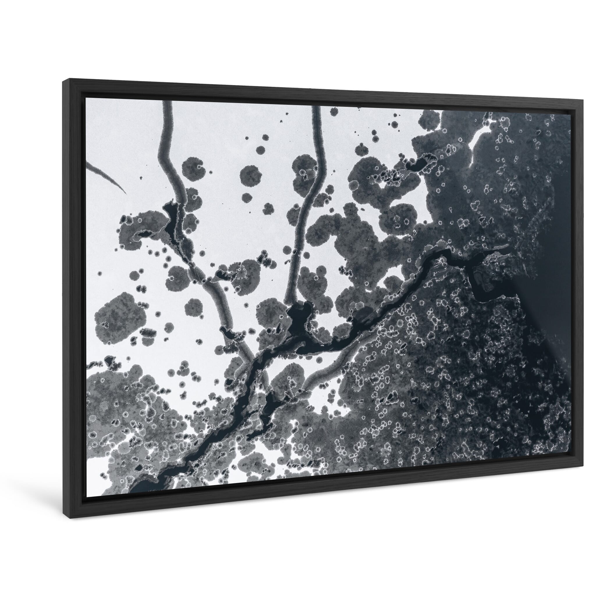 Framed photo print of bird’s-eye view of natural ice channels and dark openings